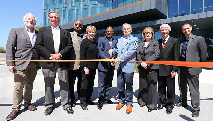 Nine people at ribbon cutting for medical research building