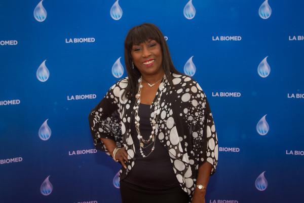 Attendee in front of LA Biomed backdrop at Spirit of Innovation Gala 2018