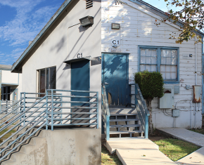 Older white building with blue trim labeled C1 and C2