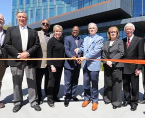 Nine people at ribbon cutting for medical research building