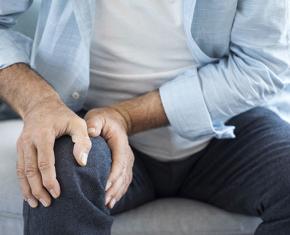 Man holding knee as if in pain